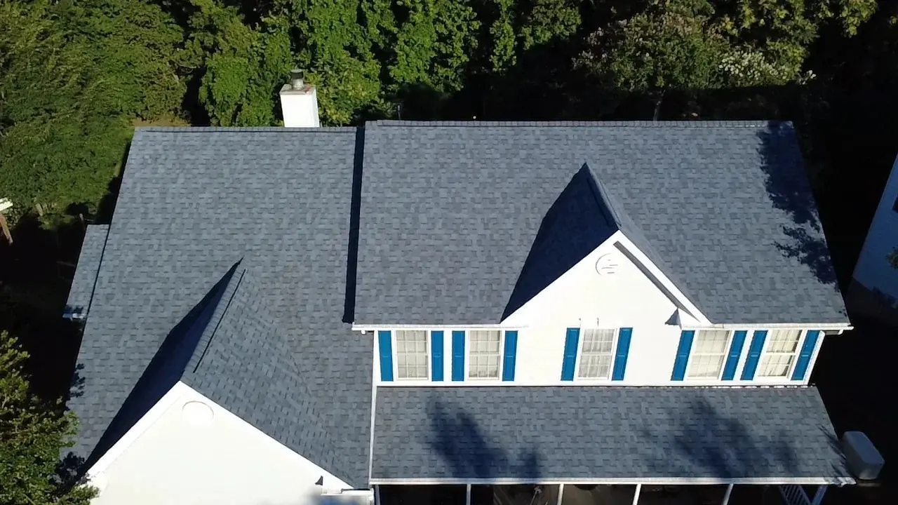 Aerial view of a freshly installed gray shingle roof
